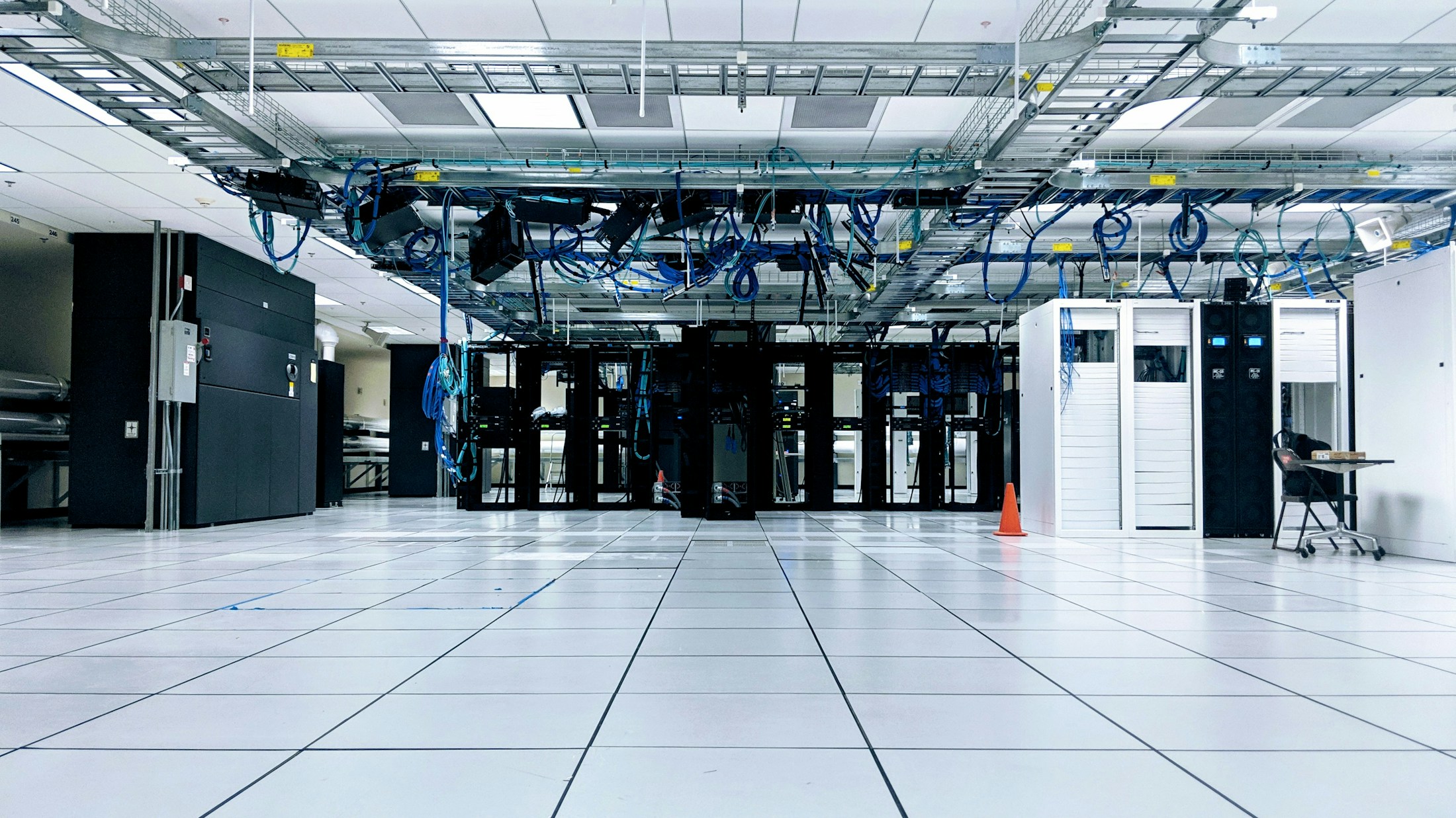 Network cabinets and overhead cabling in a bright data centre