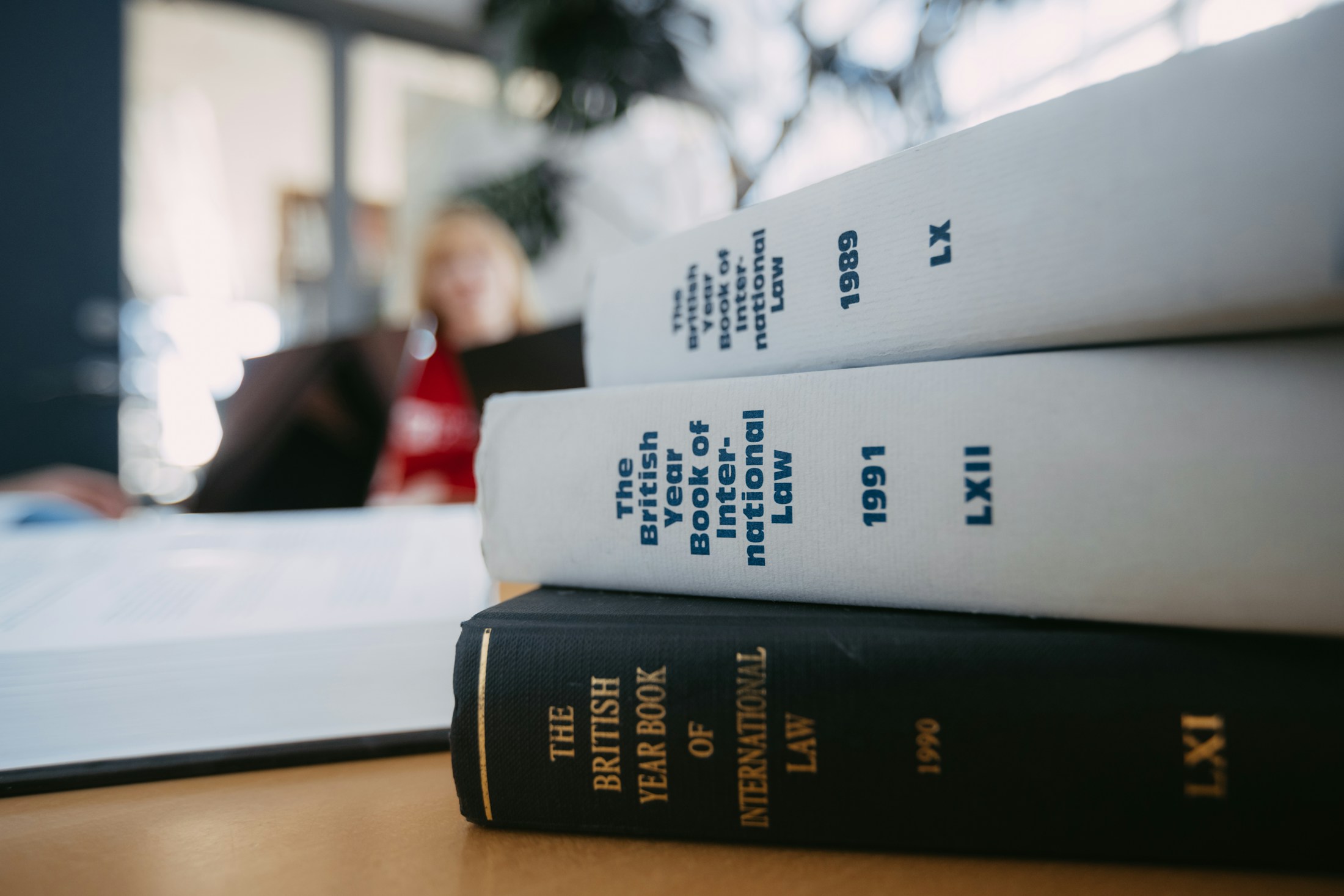 International-law reference books stacked on a reading table