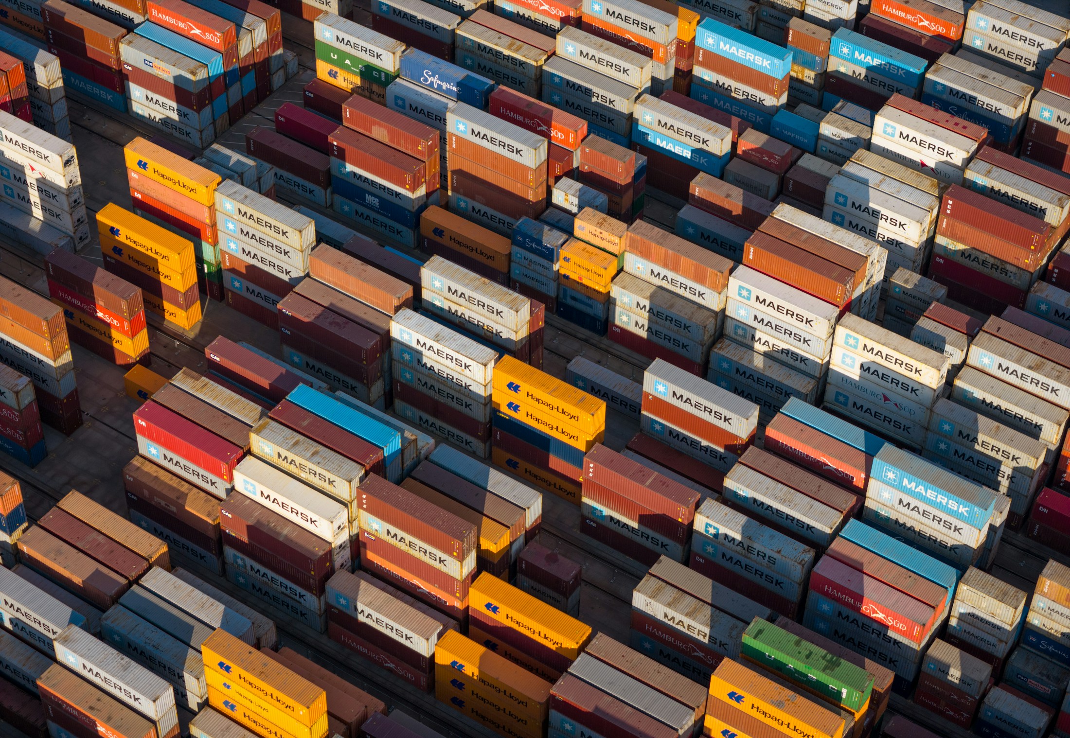 An angled aerial view of stacked shipping containers