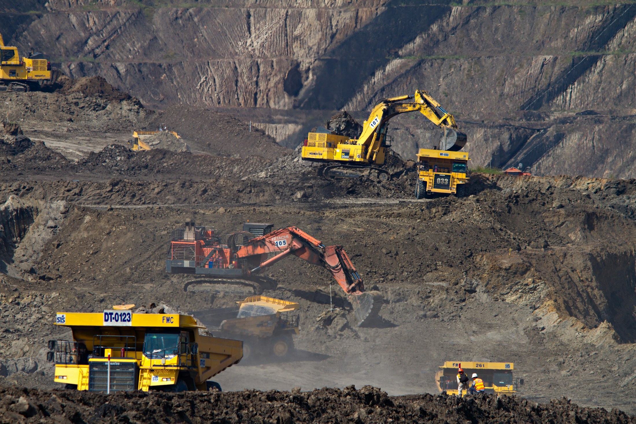 Excavators and haul trucks at a mine in South Kalimantan, Indonesia