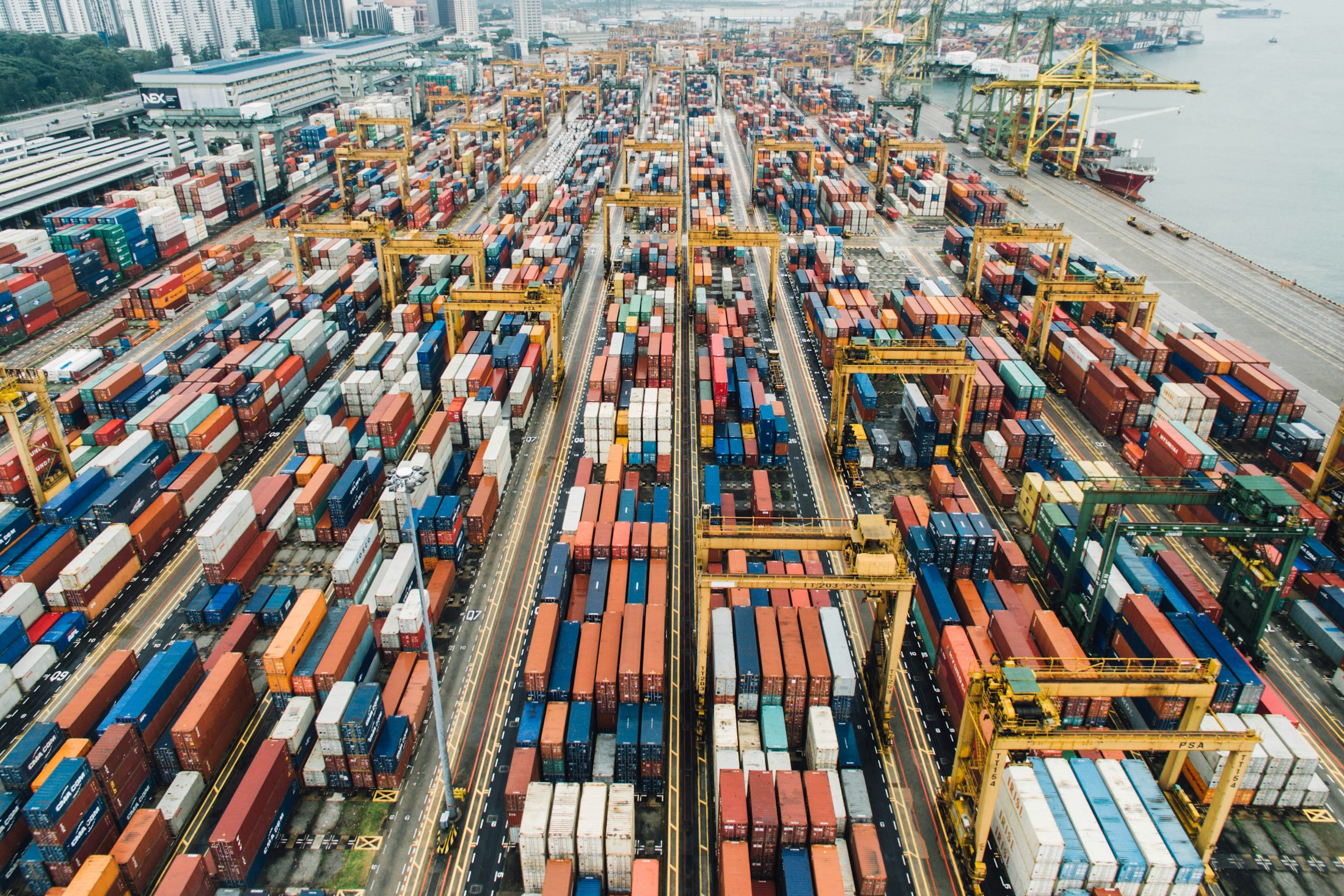Shipping containers and cranes connecting international supply chains