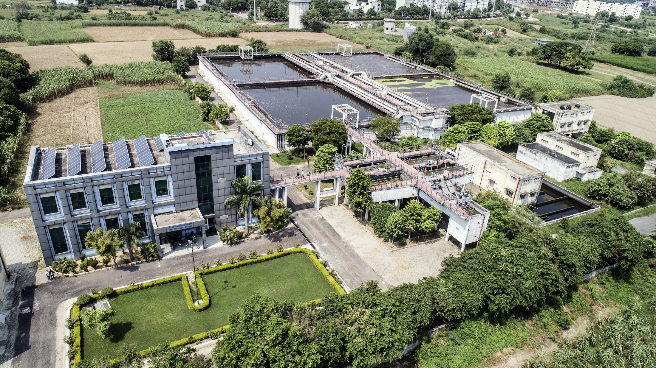 A water treatment facility surrounded by fields in daylight